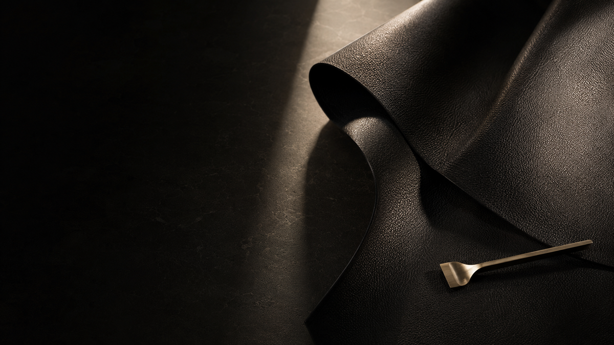 Black leather material study with brass atelier tool